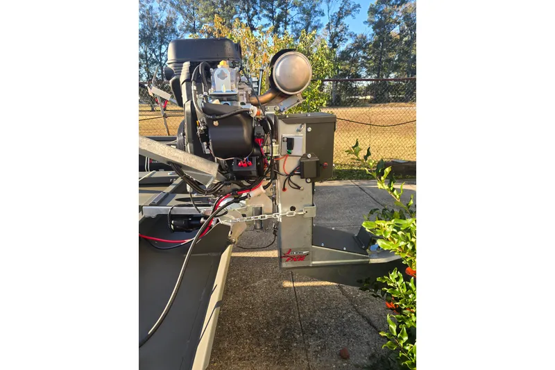 Slide: The Image of 2026 Go-Devil 18x60 Surface Drive Boat engine, outdoor setting, sunny day. - 6