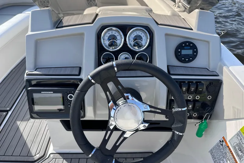 Slide: The Image of 2023 Starcraft SVX 191 OB boat dashboard with steering wheel and control panel. - 12
