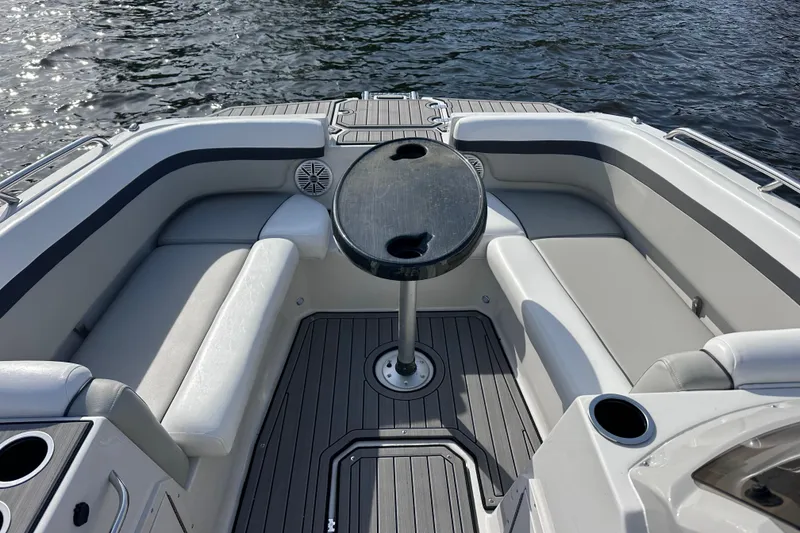 Slide: The Image of 2023 Starcraft SVX 191 OB boat interior with seating and table on water. - 15