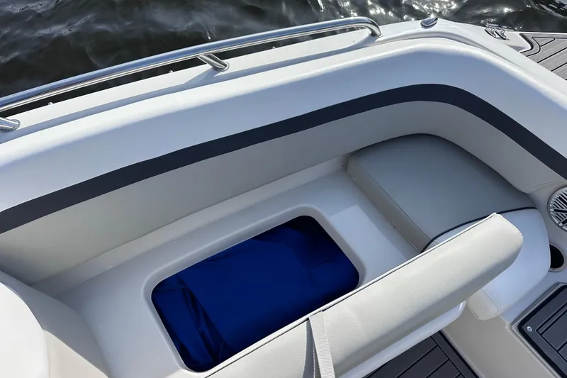 Slide: The Image of 2023 Starcraft SVX 191 OB boat interior with cushioned seating and storage compartment. - 17