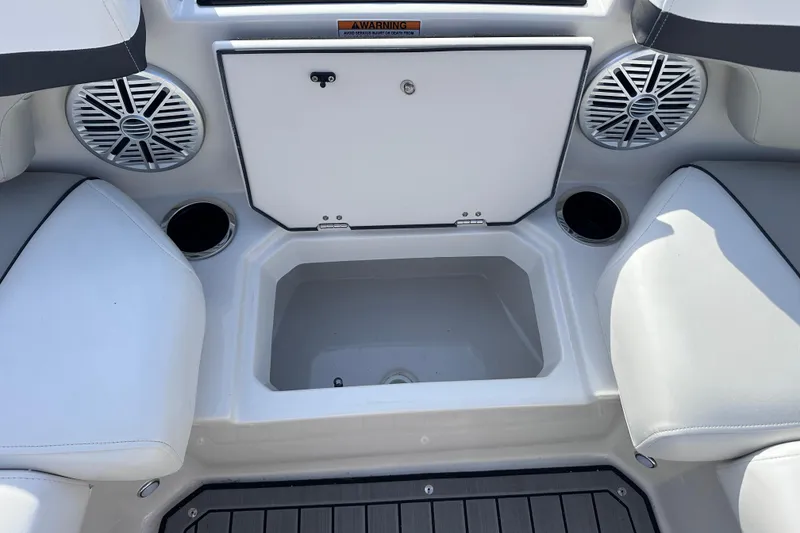 Slide: The Image of 2023 Starcraft SVX 191 OB boat interior with speakers, storage, and cup holders. - 18