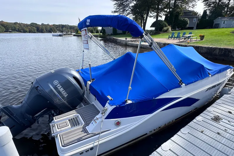Slide: The Image of 2023 Starcraft SVX 191 OB boat with blue cover and Yamaha outboard motor. - 2
