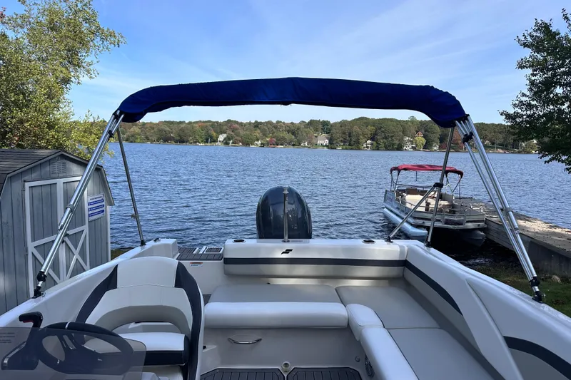 Slide: The Image of 2023 Starcraft SVX 191 OB boat with canopy on a serene lake. - 23