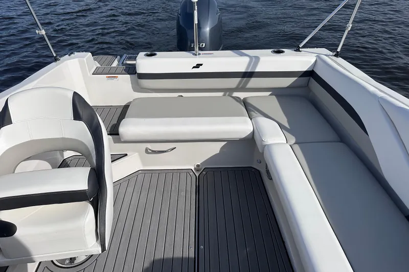 Slide: The Image of 2023 Starcraft SVX 191 OB boat interior with seating and outboard motor on water. - 5