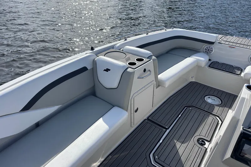 Slide: The Image of 2023 Starcraft SVX 191 OB boat interior with seating and cup holders on the water. - 8