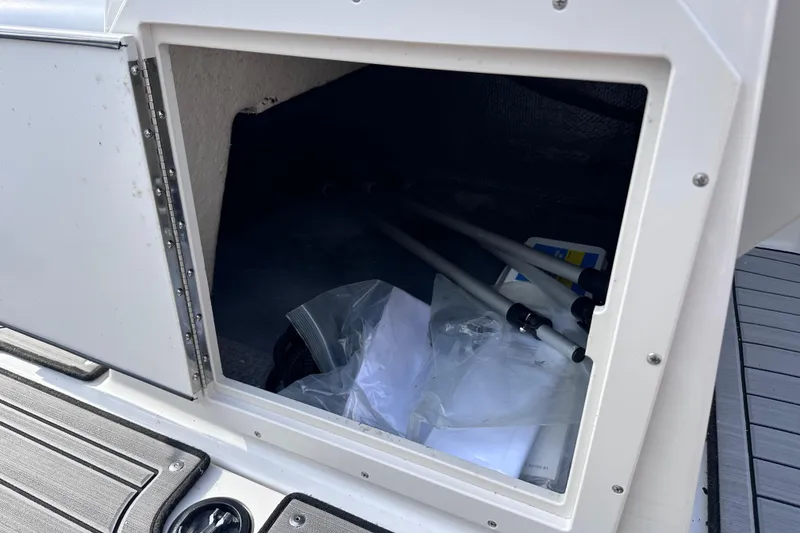 Slide: The Image of Open storage compartment on 2023 Starcraft SVX 191 OB boat, showing interior contents. - 9
