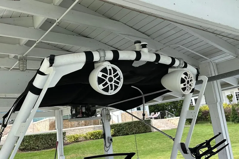 Slide: The Image of 2021 Axis A20 boat with mounted speakers under a canopy. - 13