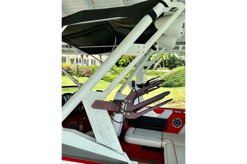 Slide: The Image of 2021 Axis A20 boat interior with wakeboard rack and seating, featuring sleek design elements. - 14