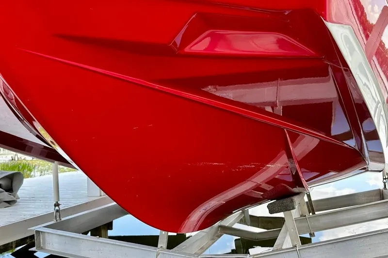 Slide: The Image of Red 2021 Axis A20 boat hull on a lift, showcasing sleek design. - 16
