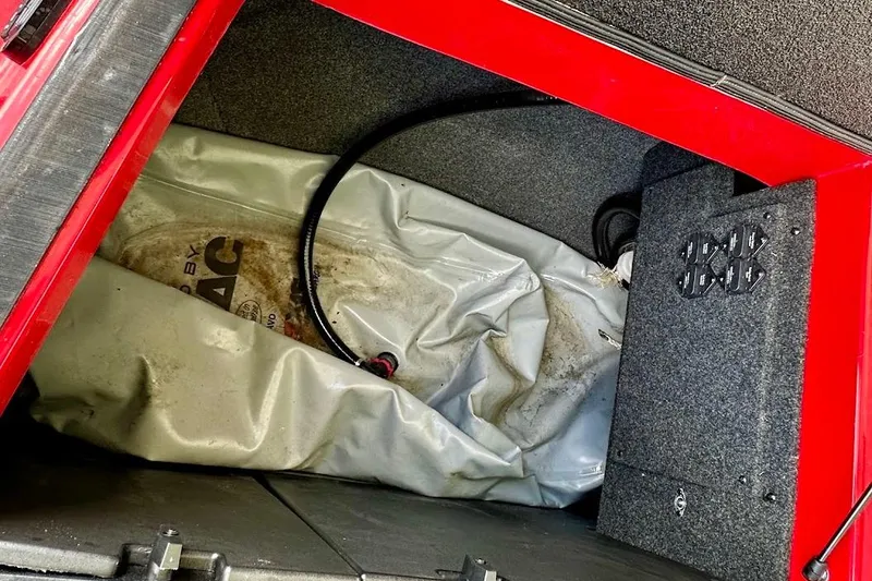 Slide: The Image of 2021 Axis A20 boat storage compartment with ballast bag and red interior. - 23