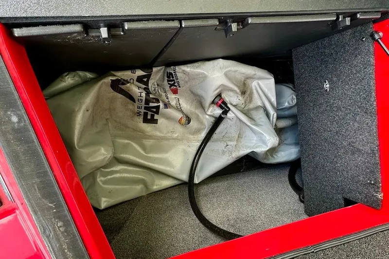 Slide: The Image of 2021 Axis A20 boat ballast bag in storage compartment. - 24