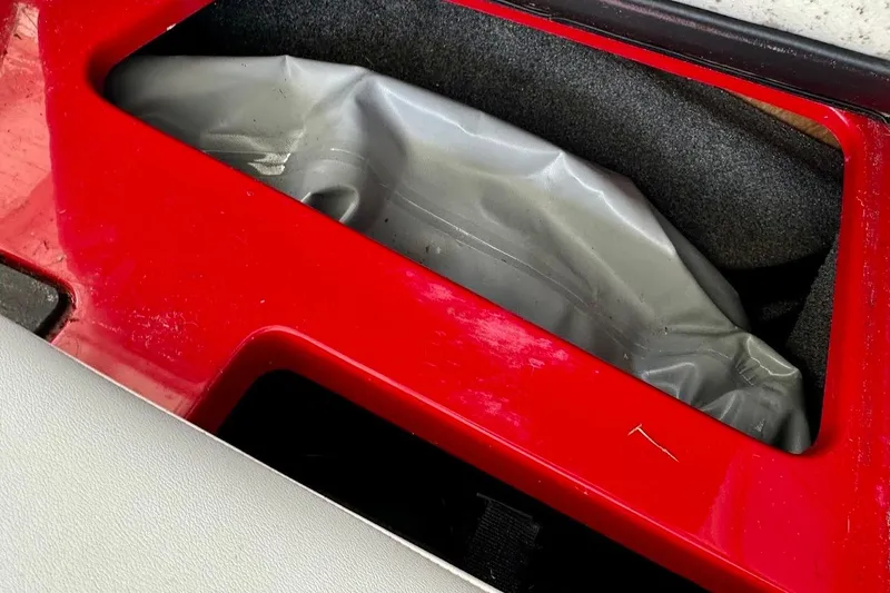 Slide: The Image of Red compartment in 2021 Axis A20 boat with gray interior lining. - 48