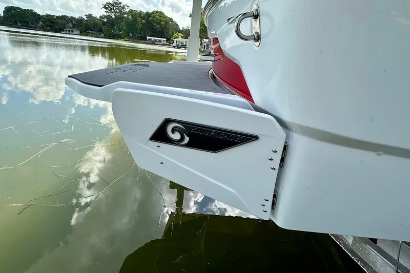 Slide: The Image of 2021 Axis A20 boat with Surf Gate feature on a calm lake. - 6