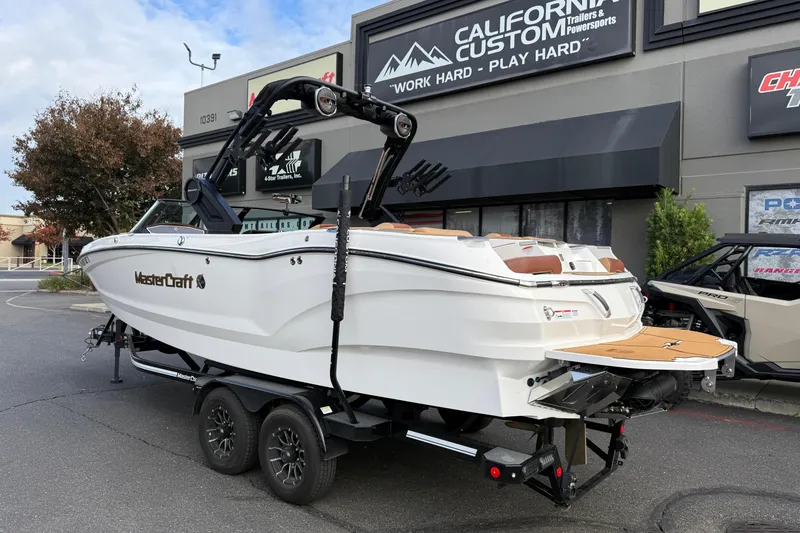 Slide: The Image of 2025 MasterCraft X24 boat on trailer outside California Custom Trailers & Powersports. - 15