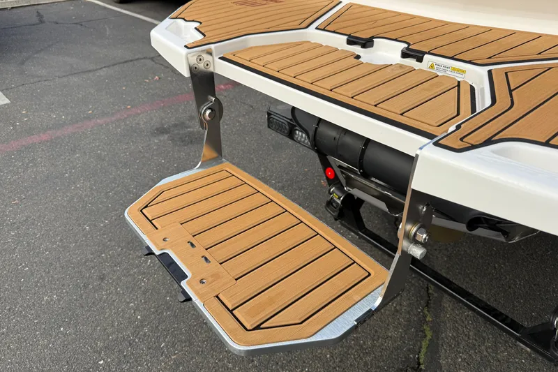 Slide: The Image of 2025 MasterCraft X24 swim platform with teak-style decking, showcasing modern design. - 26