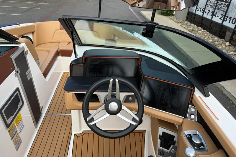 Slide: The Image of 2025 MasterCraft X24 boat interior with modern dashboard and steering wheel design. - 28