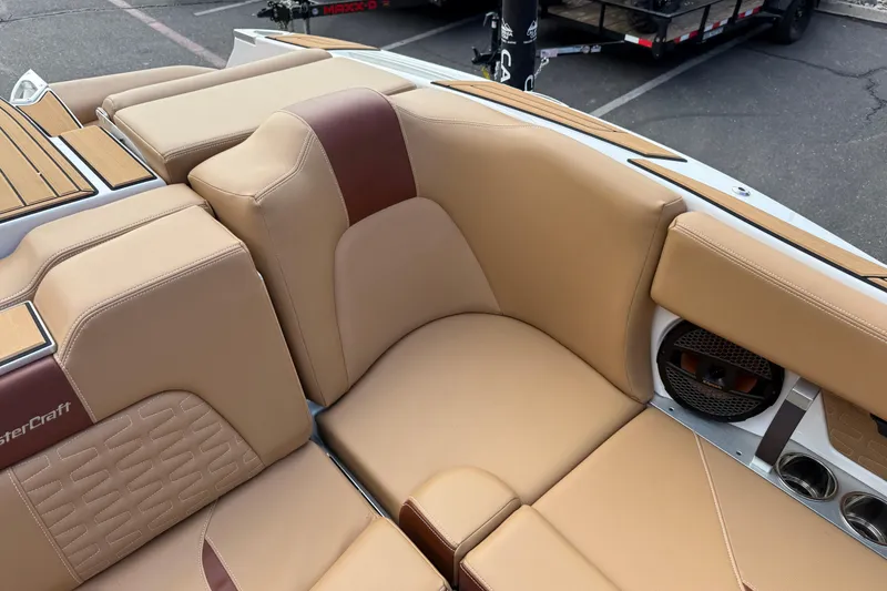 Slide: The Image of 2025 MasterCraft X24 boat interior with tan leather seating and wood accents. - 35