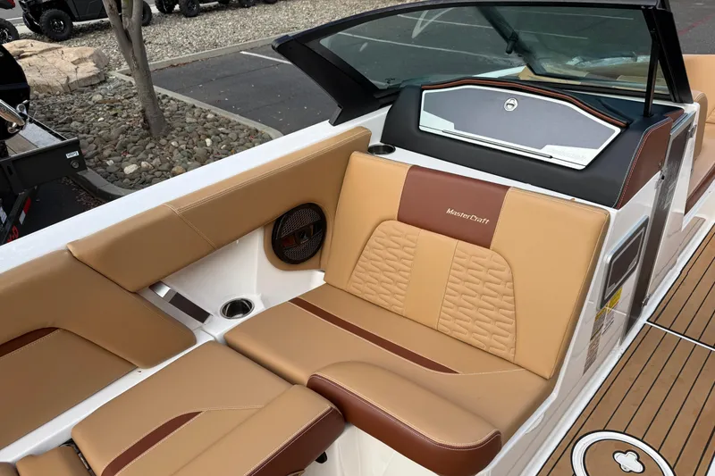 Slide: The Image of 2025 MasterCraft X24 boat interior with tan and brown seating, showcasing luxury design. - 38