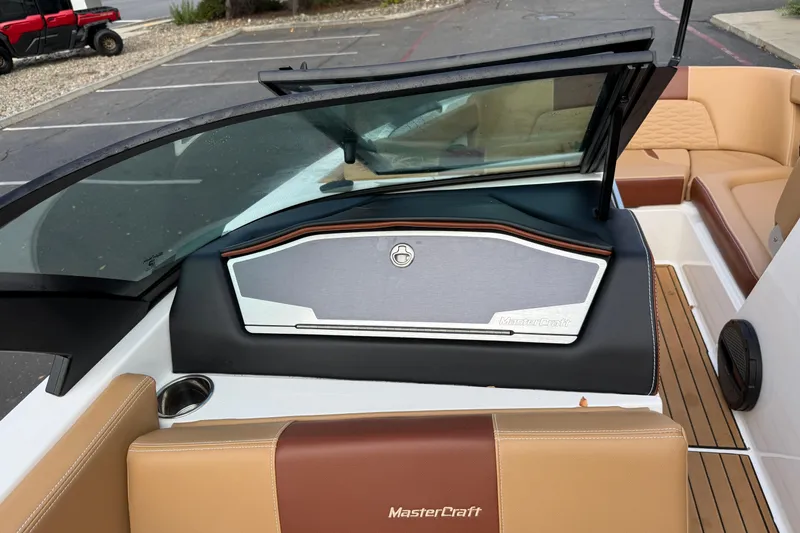 Slide: The Image of 2025 MasterCraft X24 boat interior with tan and brown seating, sleek dashboard design. - 39