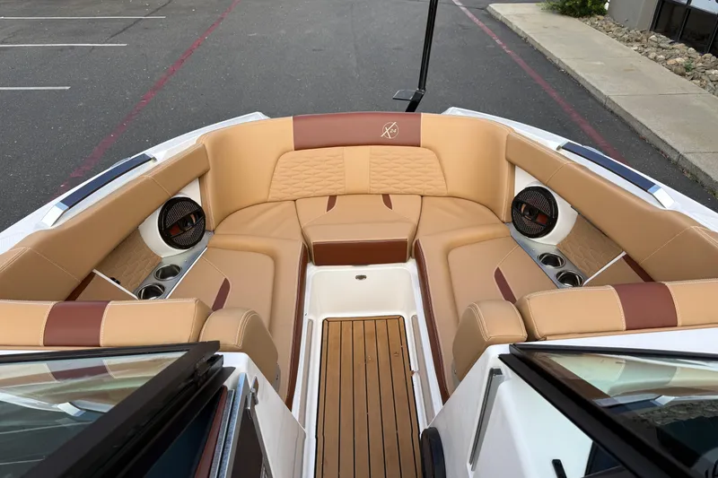 Slide: The Image of Luxurious interior of 2025 MasterCraft X24 boat with tan leather seating and wood flooring. - 40