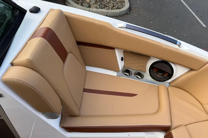 Slide: The Image of 2025 MasterCraft X24 boat interior with tan leather seating and built-in speaker system. - 41