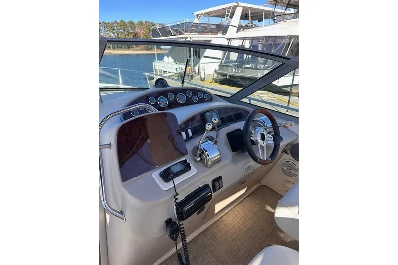 Slide: The Image of Helm of 2002 Sea Ray 340 Sundancer with steering wheel and control panel. - 12
