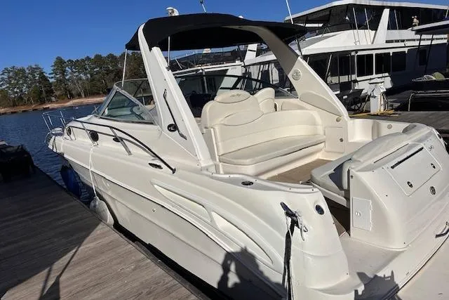 Slide: The Image of 2002 Sea Ray 340 Sundancer docked, featuring sleek design and spacious seating area. - 16