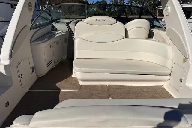 Slide: The Image of 2002 Sea Ray 340 Sundancer interior with white seating and helm area. - 18