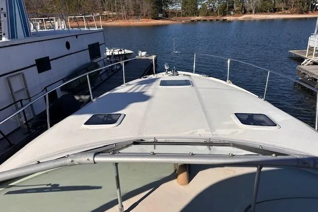 Slide: The Image of 2002 Sea Ray 340 Sundancer yacht docked on a serene lake. - 21