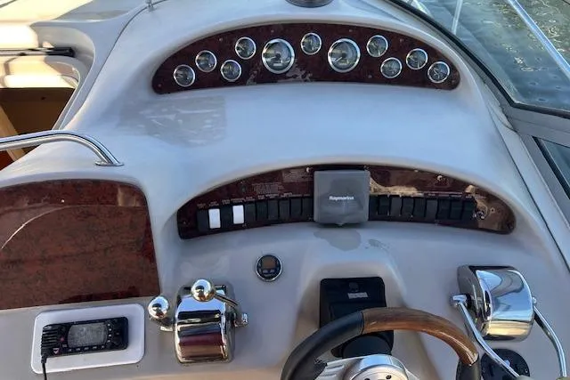 Slide: The Image of Control panel of a 2002 Sea Ray 340 Sundancer boat with gauges and switches. - 22