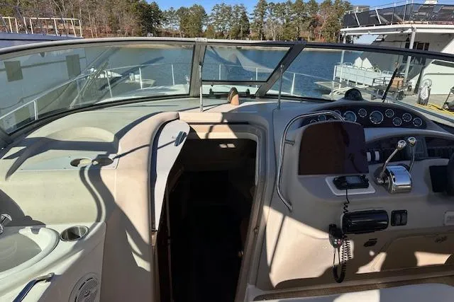 Slide: The Image of 2002 Sea Ray 340 Sundancer cockpit with steering wheel, controls, and lake view. - 23