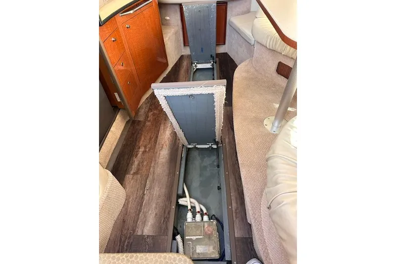 Slide: The Image of 2002 Sea Ray 340 Sundancer interior with open floor storage compartments. - 27