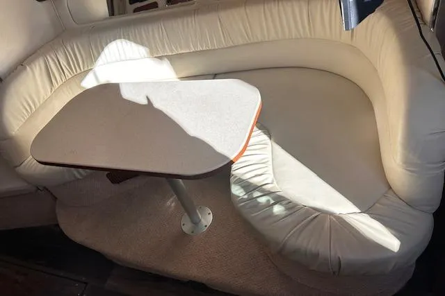 Slide: The Image of 2002 Sea Ray 340 Sundancer interior with cream leather seating and table. - 29