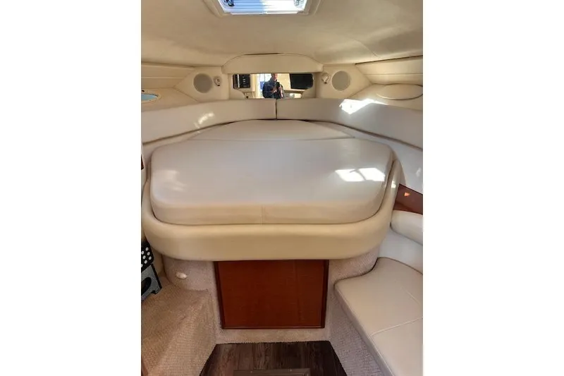 Slide: The Image of Interior cabin of 2002 Sea Ray 340 Sundancer with beige upholstery and wood accents. - 30