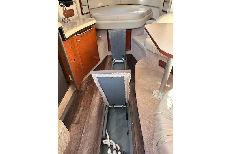 Slide: The Image of Interior of 2002 Sea Ray 340 Sundancer with open floor storage compartments. - 32