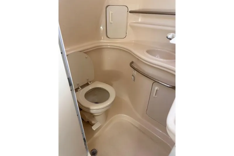 Slide: The Image of Compact bathroom in 2002 Sea Ray 340 Sundancer yacht, featuring toilet and sink. - 41
