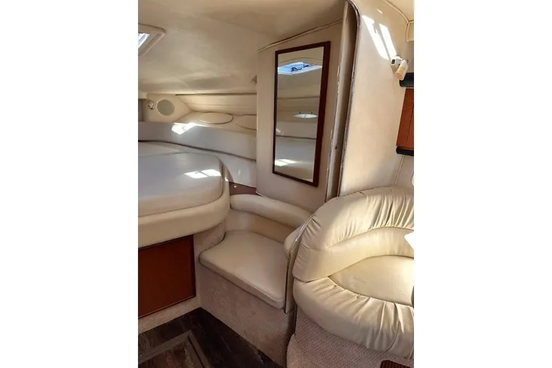 Slide: The Image of Interior of 2002 Sea Ray 340 Sundancer, featuring cream upholstery and a mirror. - 42