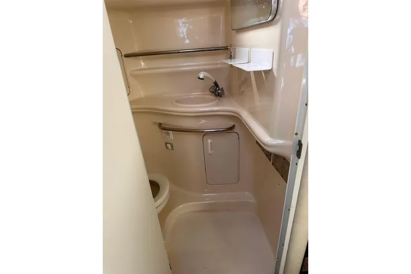 Slide: The Image of 2002 Sea Ray 340 Sundancer bathroom with sink, toilet, and storage cabinet. - 46