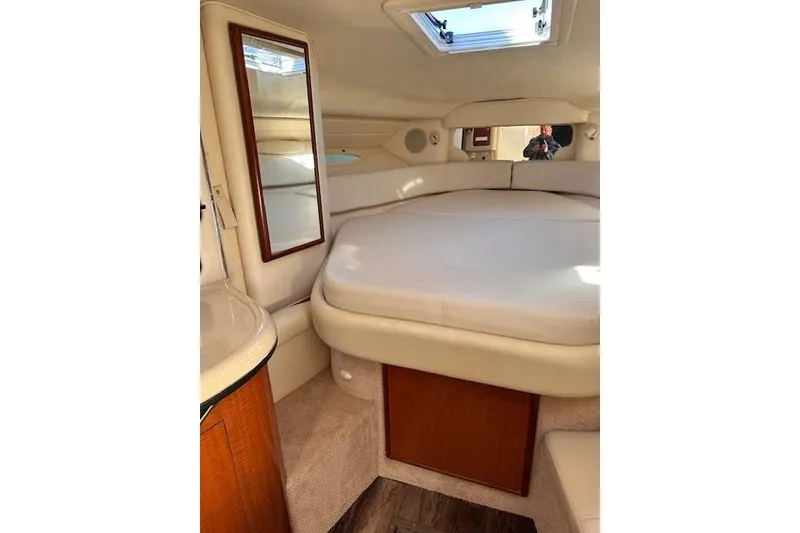 Slide: The Image of 2002 Sea Ray 340 Sundancer cabin interior with bed, mirror, and skylight. - 47