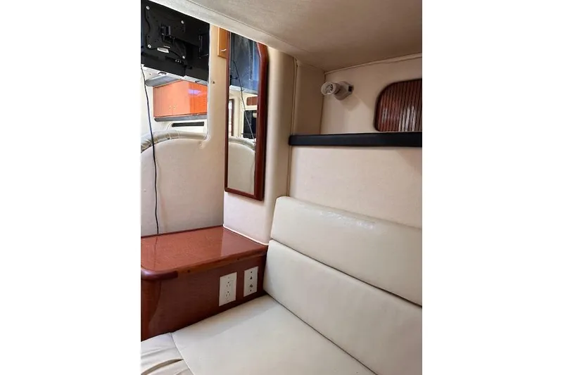 Slide: The Image of Interior of 2002 Sea Ray 340 Sundancer with seating, mirror, and wood accents. - 50