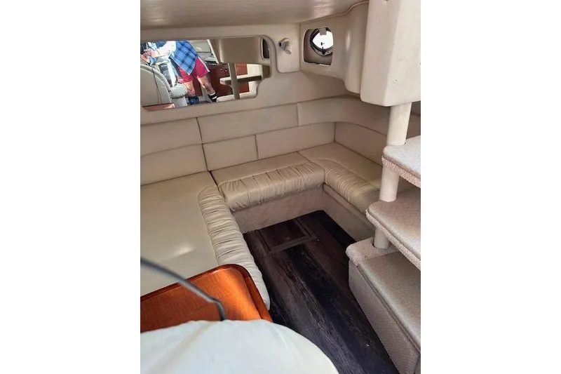 Slide: The Image of Interior of 2002 Sea Ray 340 Sundancer with beige seating and wooden accents. - 56