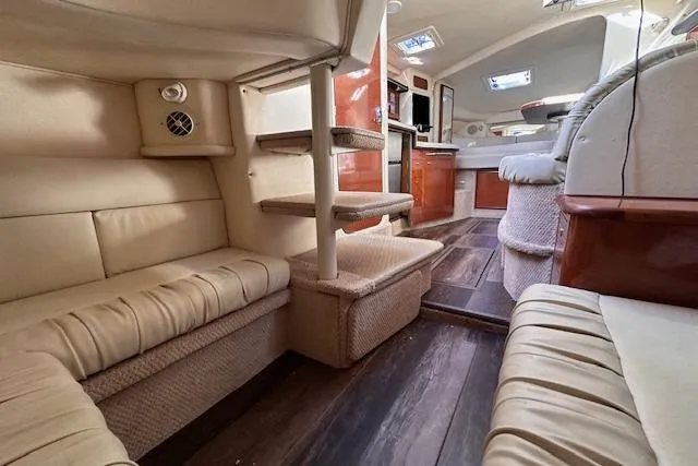 Slide: The Image of Luxurious interior of 2002 Sea Ray 340 Sundancer yacht with plush seating and wooden flooring. - 58
