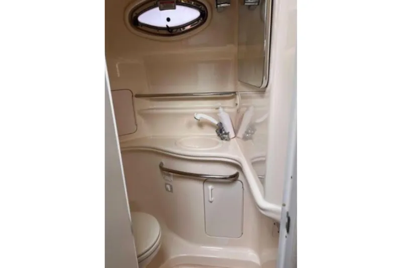 Slide: The Image of 2002 Sea Ray 340 Sundancer bathroom with sink, mirror, and compact design. - 59