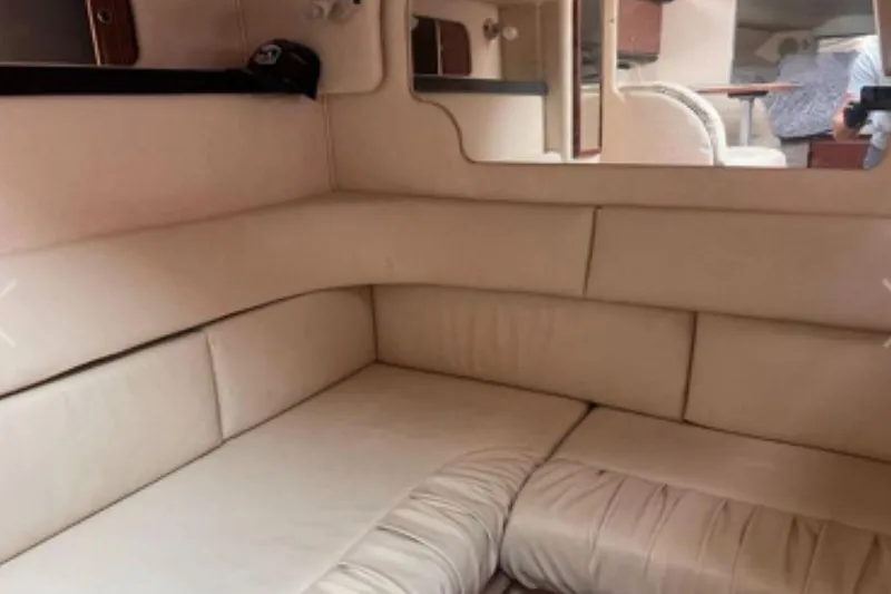 Slide: The Image of Interior of 2002 Sea Ray 340 Sundancer with beige seating and mirrored wall. - 60