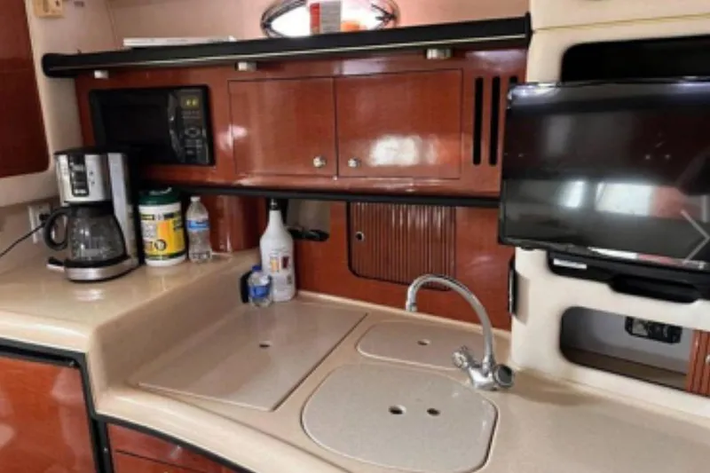 Slide: The Image of 2002 Sea Ray 340 Sundancer kitchen with sink, coffee maker, and microwave. - 61