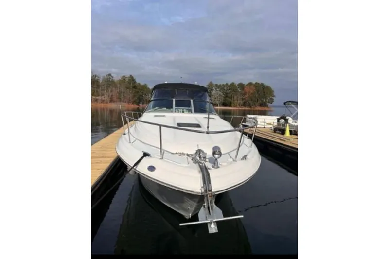 Slide: The Image of 2002 Sea Ray 340 Sundancer docked at a marina, front view. - 64