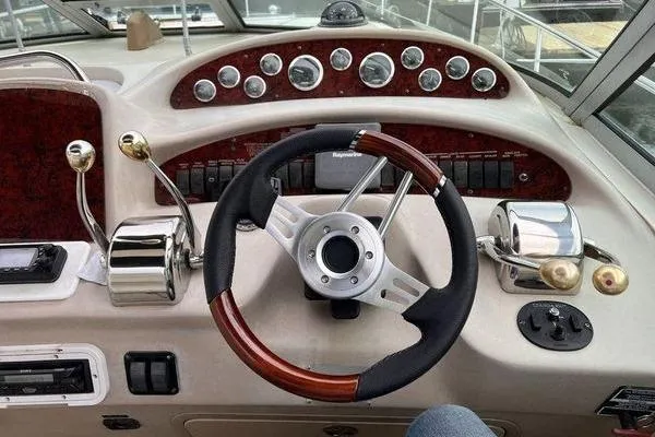 Slide: The Image of Cockpit of 2002 Sea Ray 340 Sundancer with steering wheel and control panel. - 66