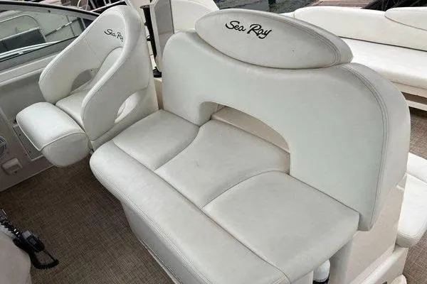 Slide: The Image of 2002 Sea Ray 340 Sundancer boat interior with white seating and logo. - 67