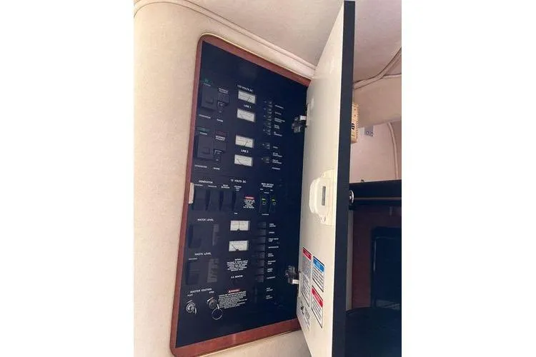Slide: The Image of Electrical panel inside a 2002 Sea Ray 340 Sundancer boat cabin. - 72