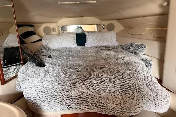 Slide: The Image of Cozy cabin interior of 2002 Sea Ray 340 Sundancer with plush bedding. - 76